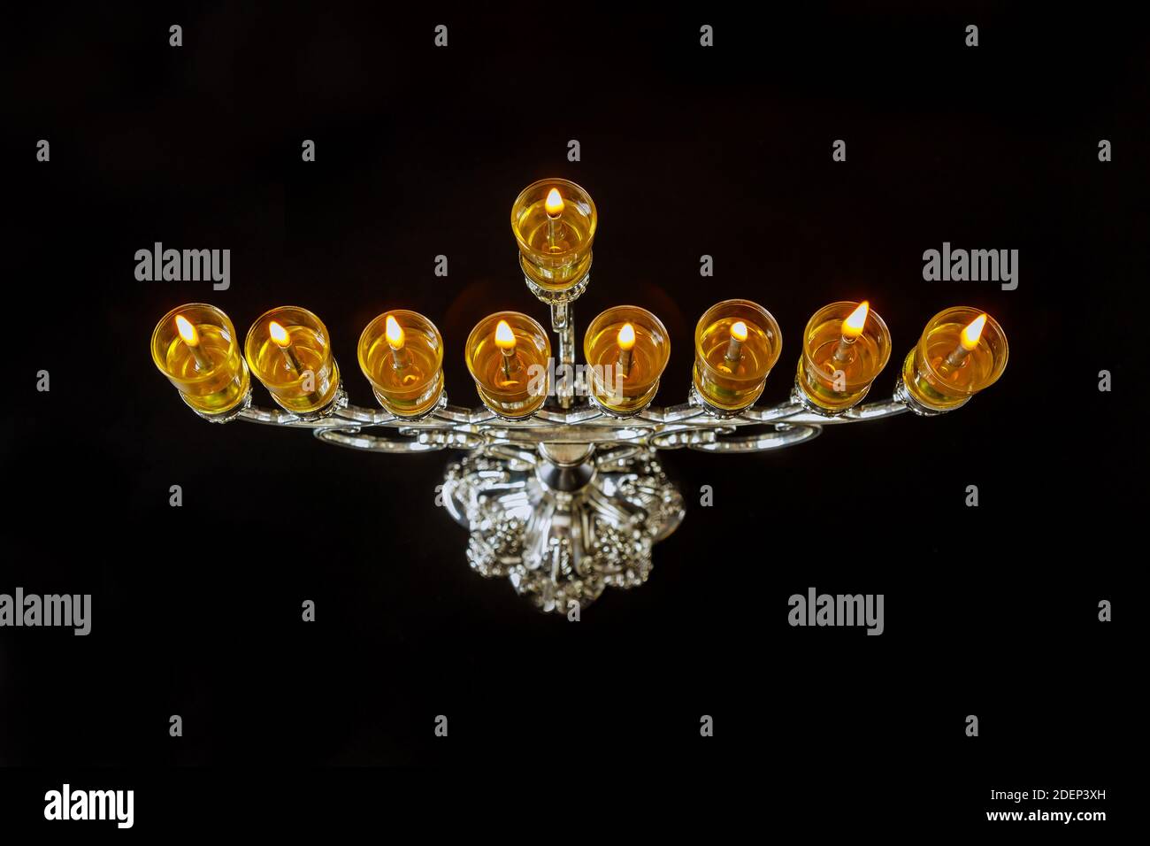 Menorah Hanukkah oil candles are burning in hanukkiah on light of