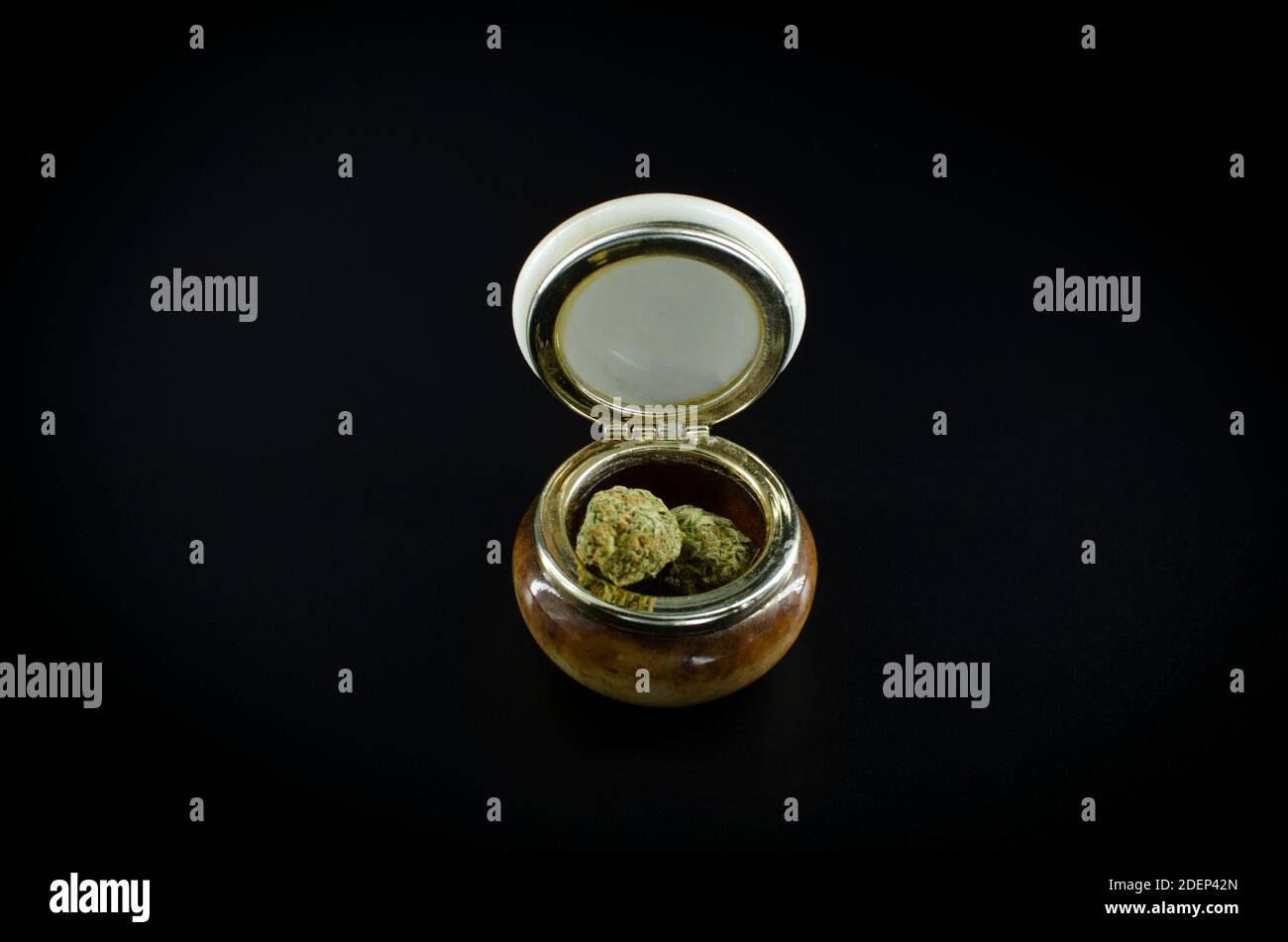 Weed. Cannabis Buds On A ceramic Jar Isolated Over Black Background Stock Photo