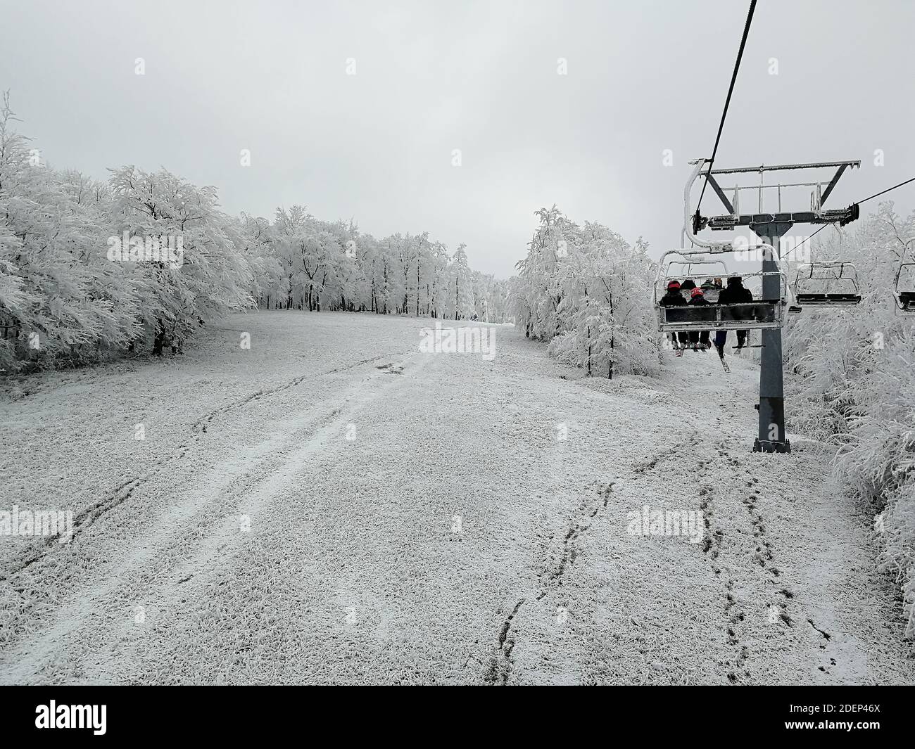 Skiers ride chair lift hi-res stock photography and images - Alamy