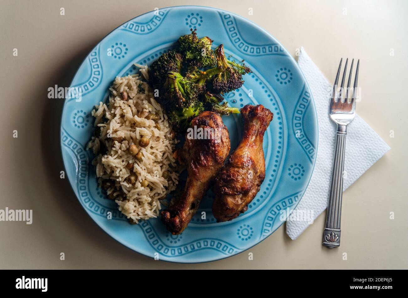 Authentic spicy Jamaican jerk chicken legs served with coconut rice and