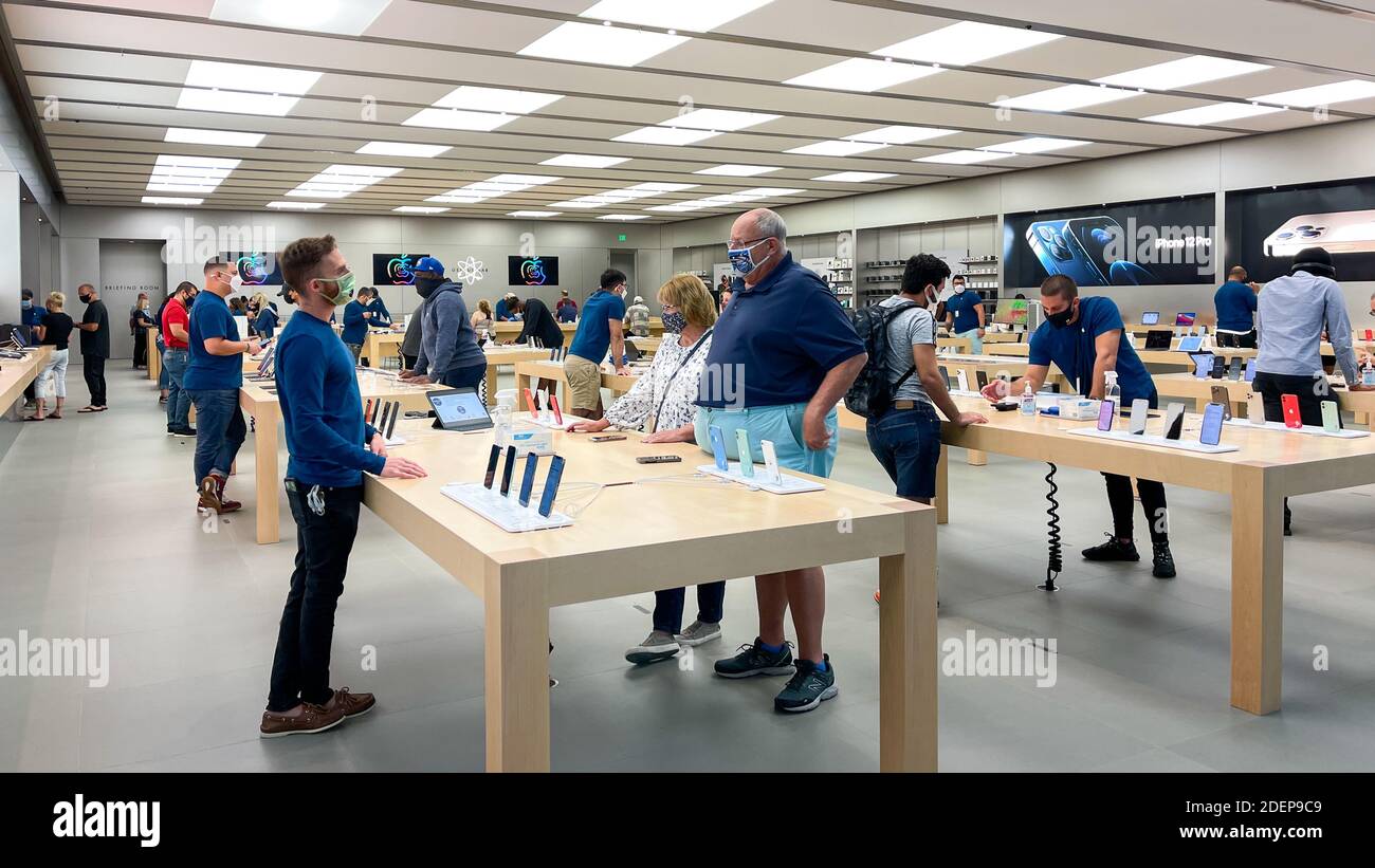 Orlando, FL USA - November 20, 2020: A salesperson and customers at an Apple  store looking at the latest Apple iPhone 12 models for sale Stock Photo -  Alamy