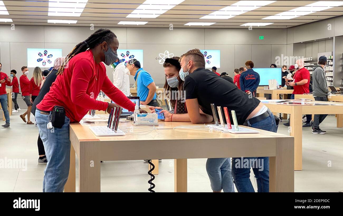 Orlando, FL USA - November 20, 2020: A salesperson and customers at an Apple  store looking at the latest Apple iPhone 12 models for sale Stock Photo -  Alamy