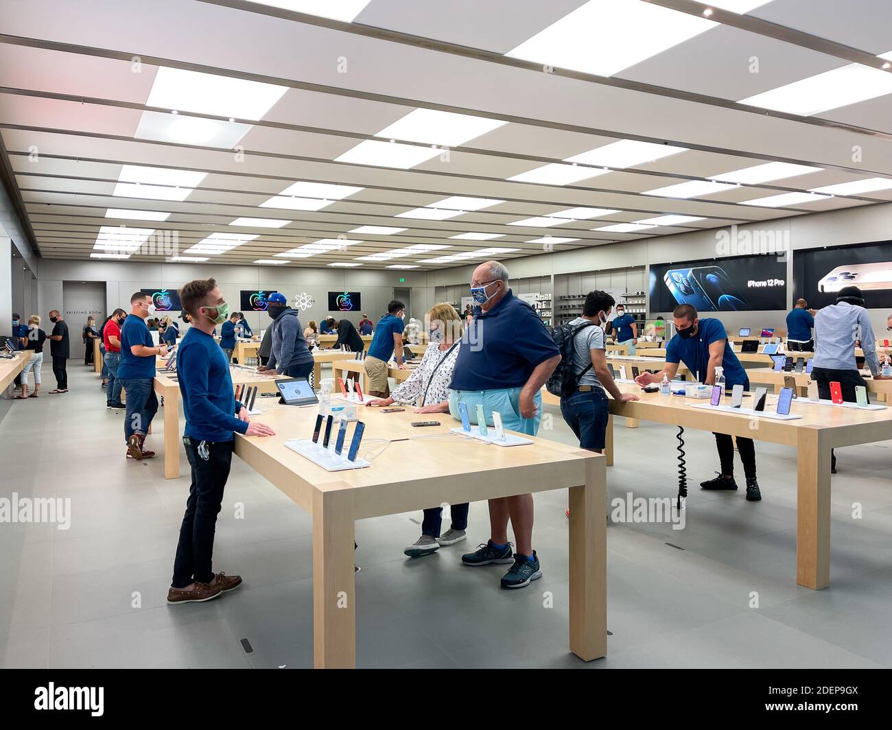 Orlando, FL USA - November 20, 2020: Salespeople and customers at an Apple  store looking at the latest Apple products for sale Stock Photo - Alamy