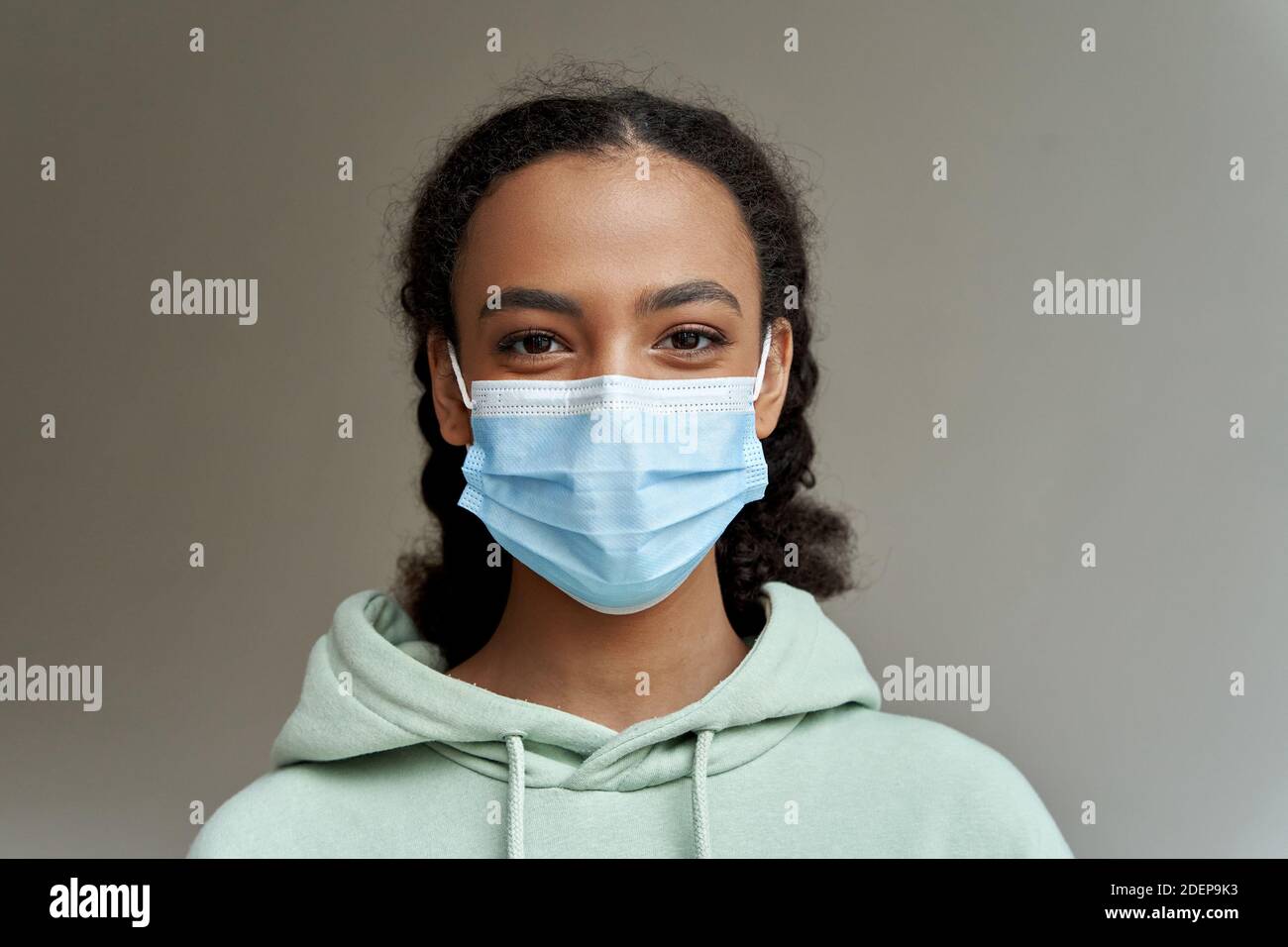 African american teen girl wearing face mask looking at camera, headshot. Stock Photo