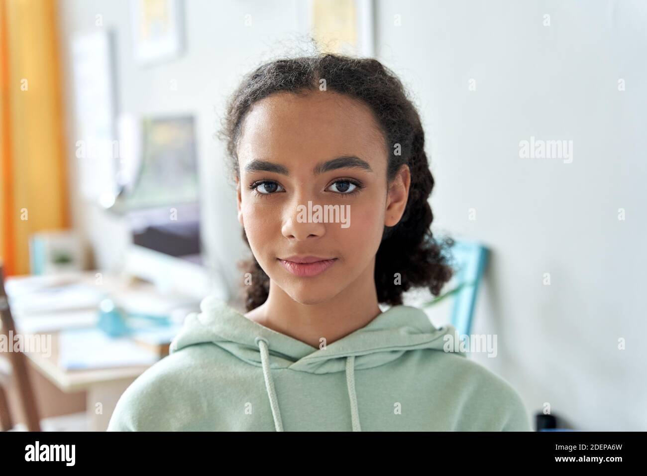 African american mixed race teen girl looking at camera at home, portrait  Stock Photo - Alamy