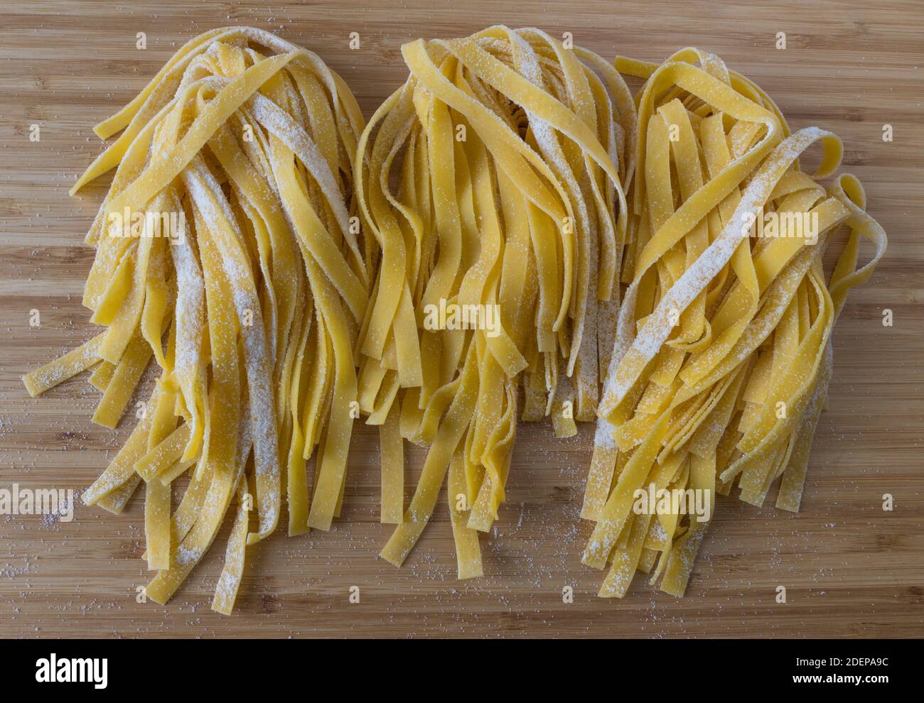 closeup of three portions of fresh homemade pasta in a raw, high angle view from above Stock Photo
