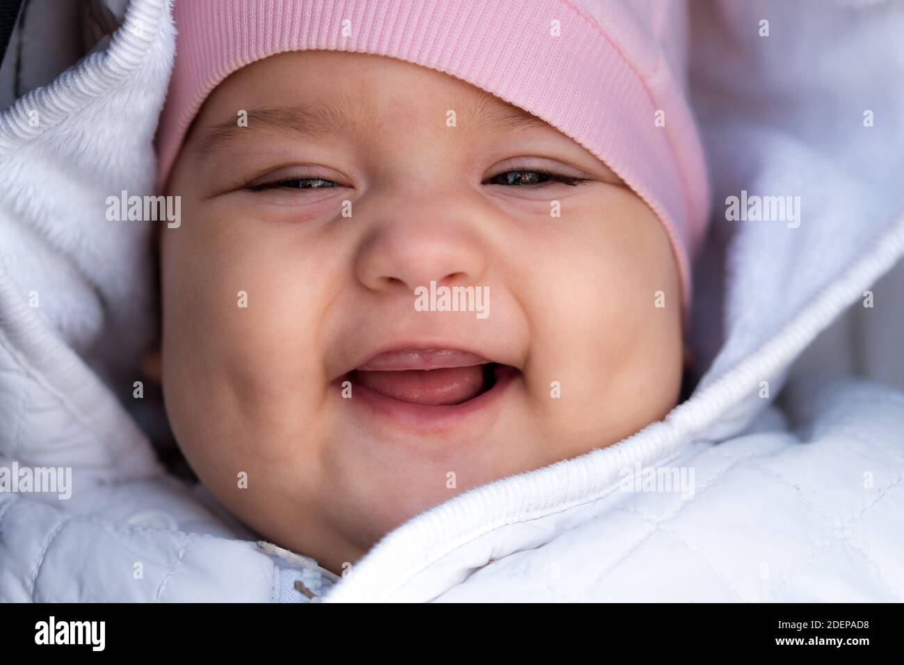 Infant Childhood Emotion Concept Close Up Of Cute Smiling Portrait Face Of Brown Eyed Chubby Newborn Awake Toothless Baby 6 9 Month Old Looking At Stock Photo Alamy