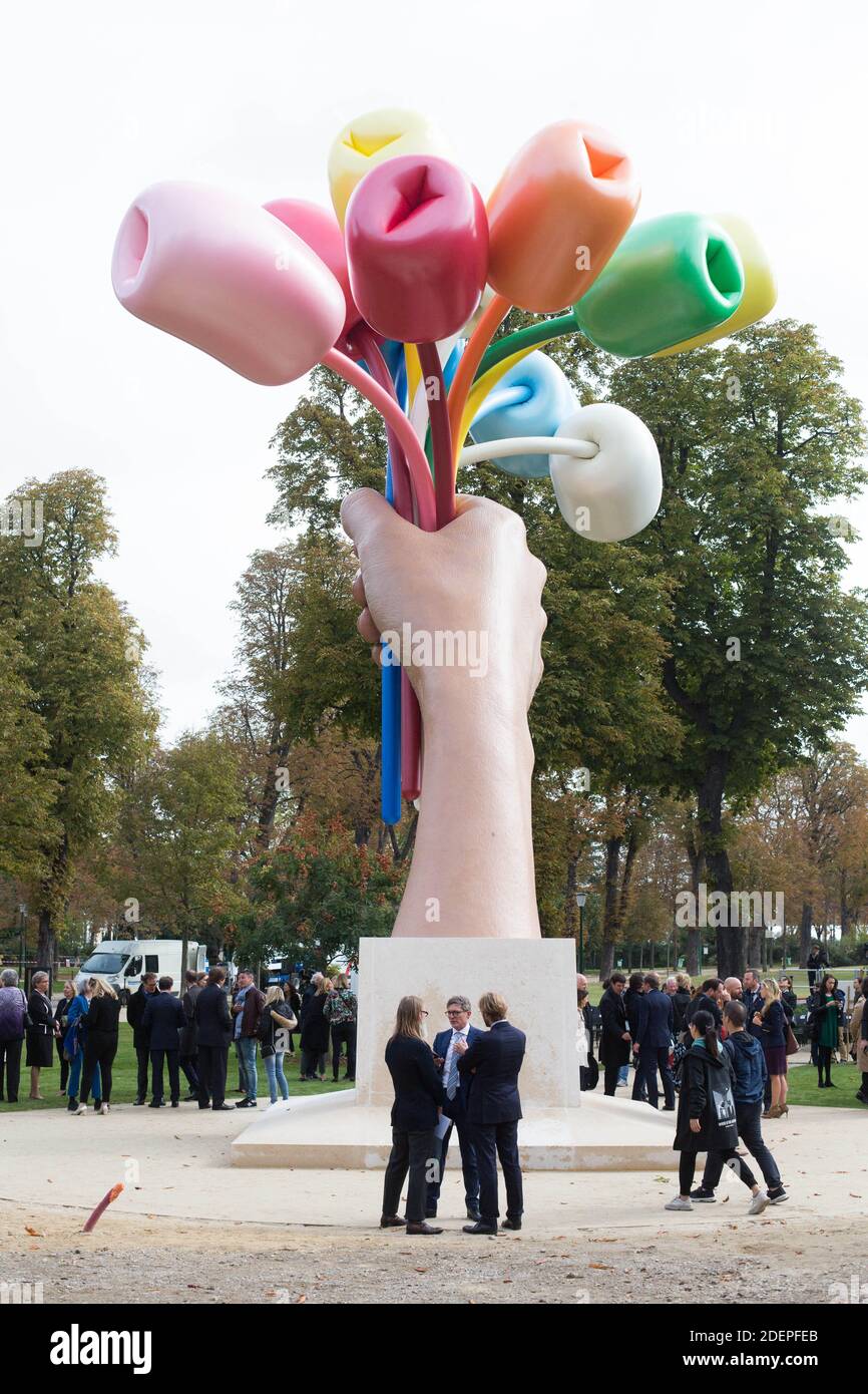 Media representatives and bystanders gather at the unveiling of the