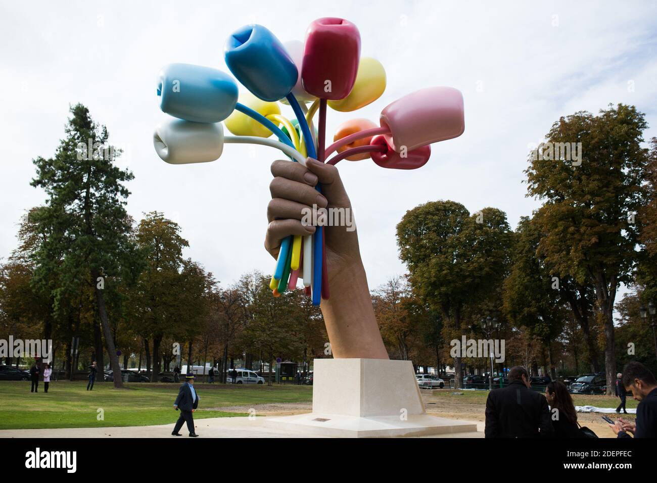 Media representatives and bystanders gather at the unveiling of the