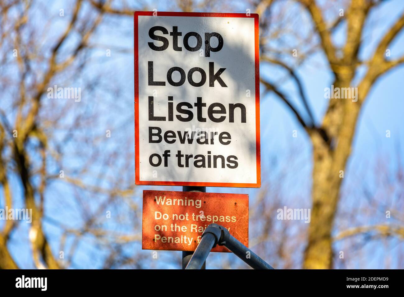 Stop, Look, Listen - Beware of Trains sign - on unmanned crossing point in UK Stock Photo