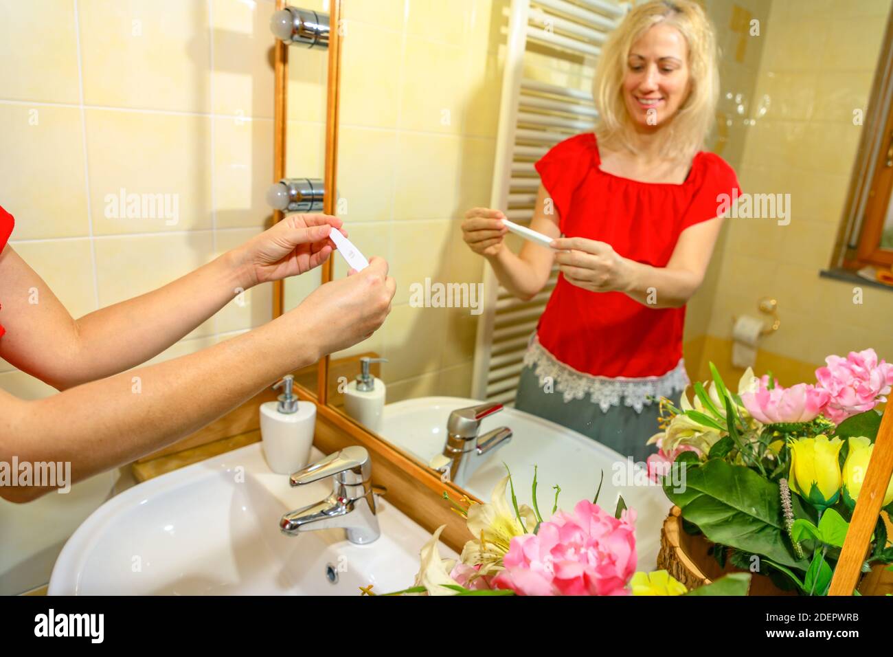 Woman in toilet with pregnancy test. Concept of motherhood and ...
