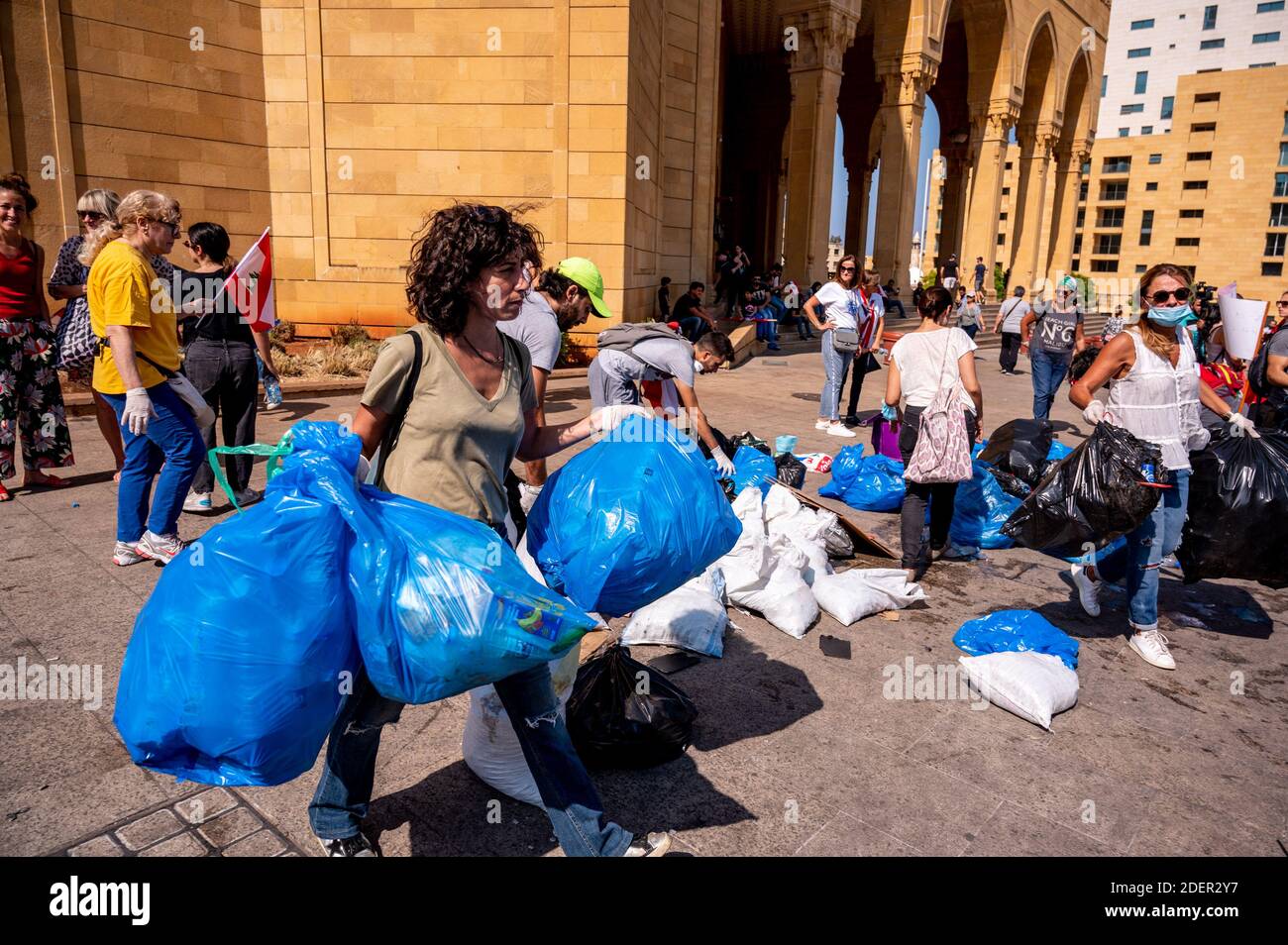 Lebanese demonstrators clean rubbish in Beirut on October 19, 2019, after demonstrations swept through the eastern Mediterranean country in protest against dire economic conditions. Tens of thousands of people took to the streets for a third day of protests against tax increases and alleged official corruption. The protesters took to the streets despite calls for calm from politicians and dozens of arrests on Friday. Many waved billowing Lebanese flags and insisted the protests should remain peaceful and non-sectarian. The demonstrators are demanding a sweeping overhaul of Lebanon's political Stock Photo