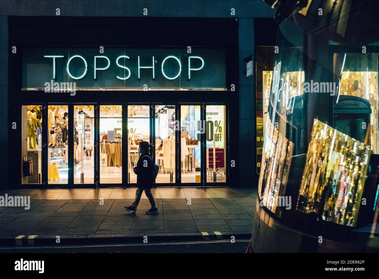 Oxford Street, London: 1st December 2020. A pedestrian walks past a closed  Topshop on Oxford Street. On 30 November, 2020, it was announced that  Topshop, owned by the Arcadia Group, had gone