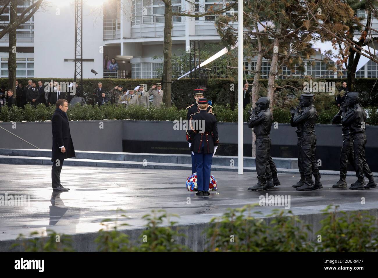 French President Emmanuel Macron (L) pays his respects in front of the 'Monument aux morts pour la France en operations exterieures' (OPEX) by French artist Stephane Vigny during its official inauguration on November 11, 2019 in the Eugenie-Djendi garden in Paris, as part of commemorations marking the 101st anniversary of the 11 November 1918 armistice, ending World War I. Photo by Ludovic MARIN/Pool/ABACAPRESS.COM Stock Photo