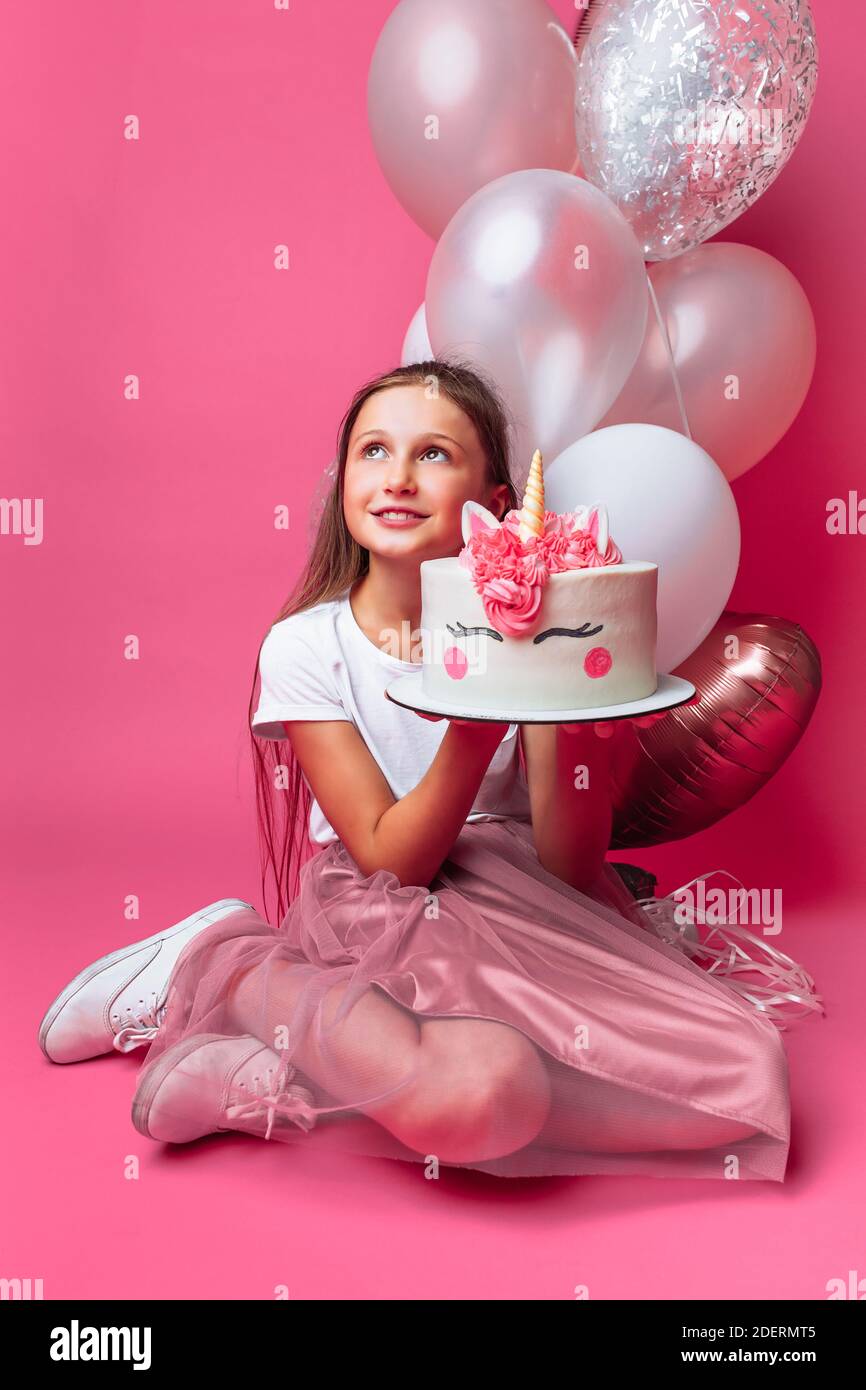 Smiling Woman Sitting and Posing with Birthday Balloons · Free Stock Photo