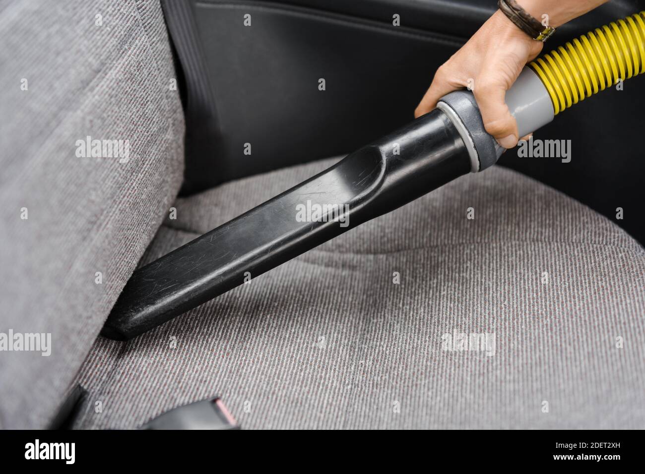 Vacuuming the car seat bench with vehicle vacuum cleaner carwash Stock Photo