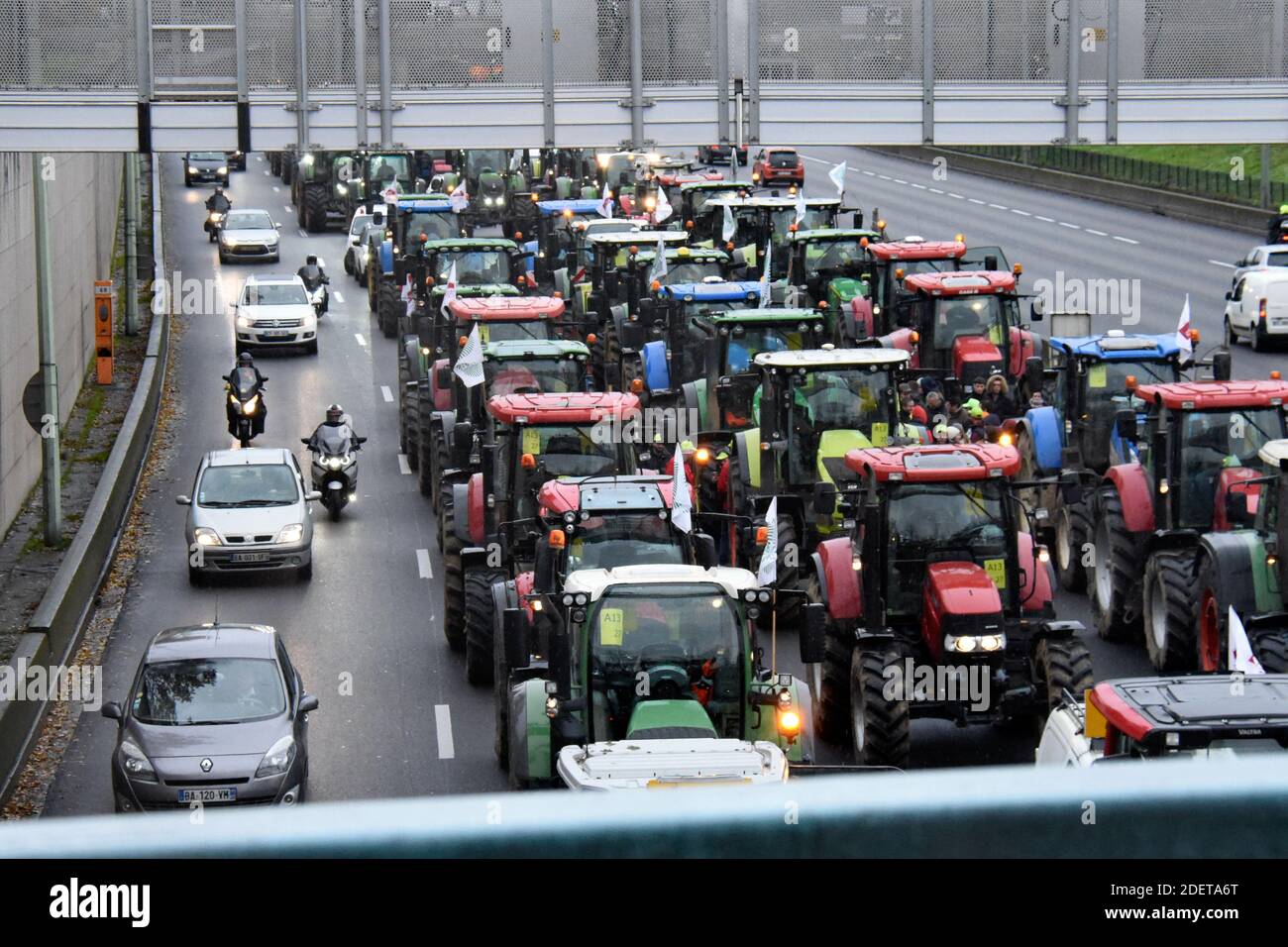 French farmers steer their tractors on The Parisian ring road (Peripherique)  at Porte de Champerret in Paris on November 27, 2019, during a protest  against government policies. Hundreds of French farmers descended