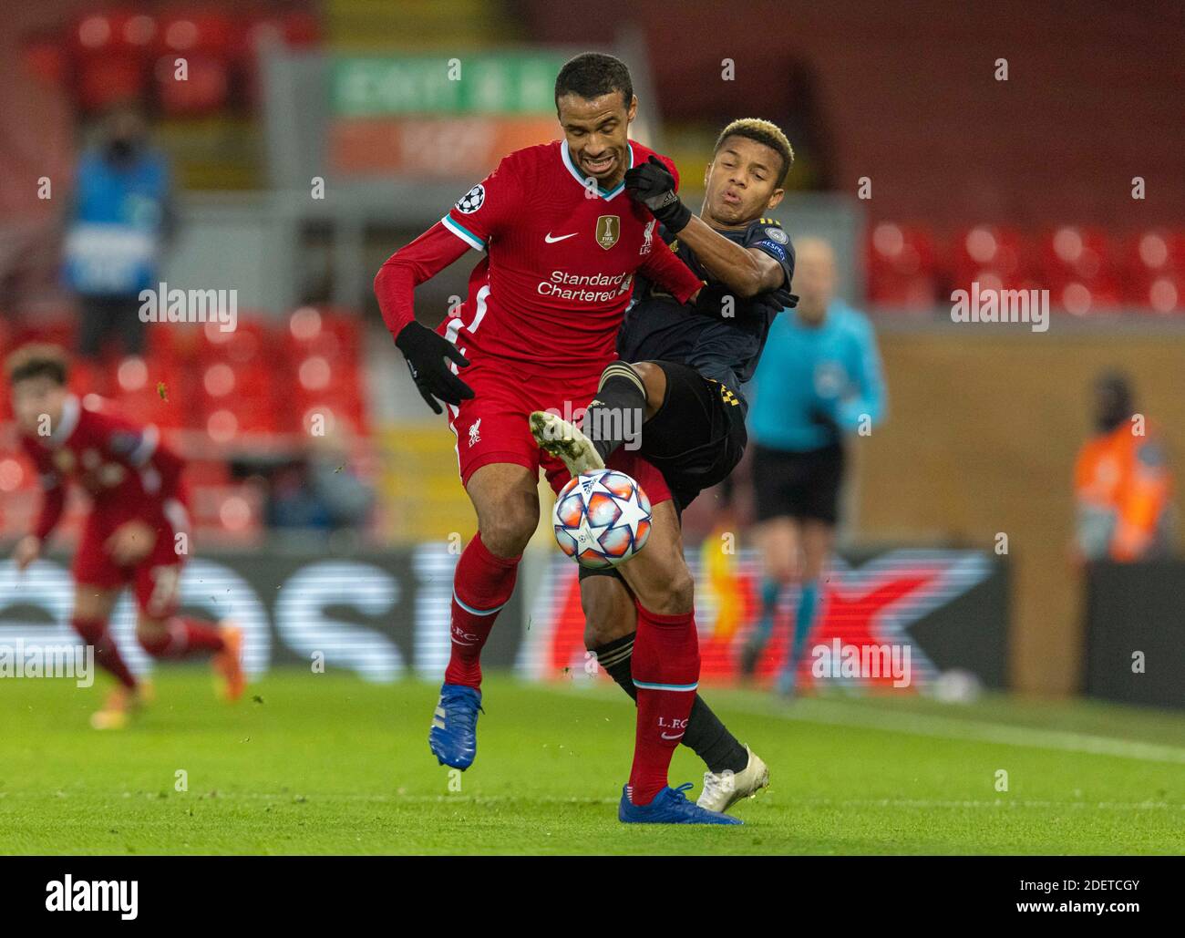 Liverpool. 1st Dec, 2020. Liverpool's Joel Matip (L) is tackled by Ajax's David Neres during the UEFA Champions League match between Liverpool FC and AFC Ajax at Anfield in Liverpool, Britain, on Dec. 1, 2020. Credit: Xinhua/Alamy Live News Stock Photo