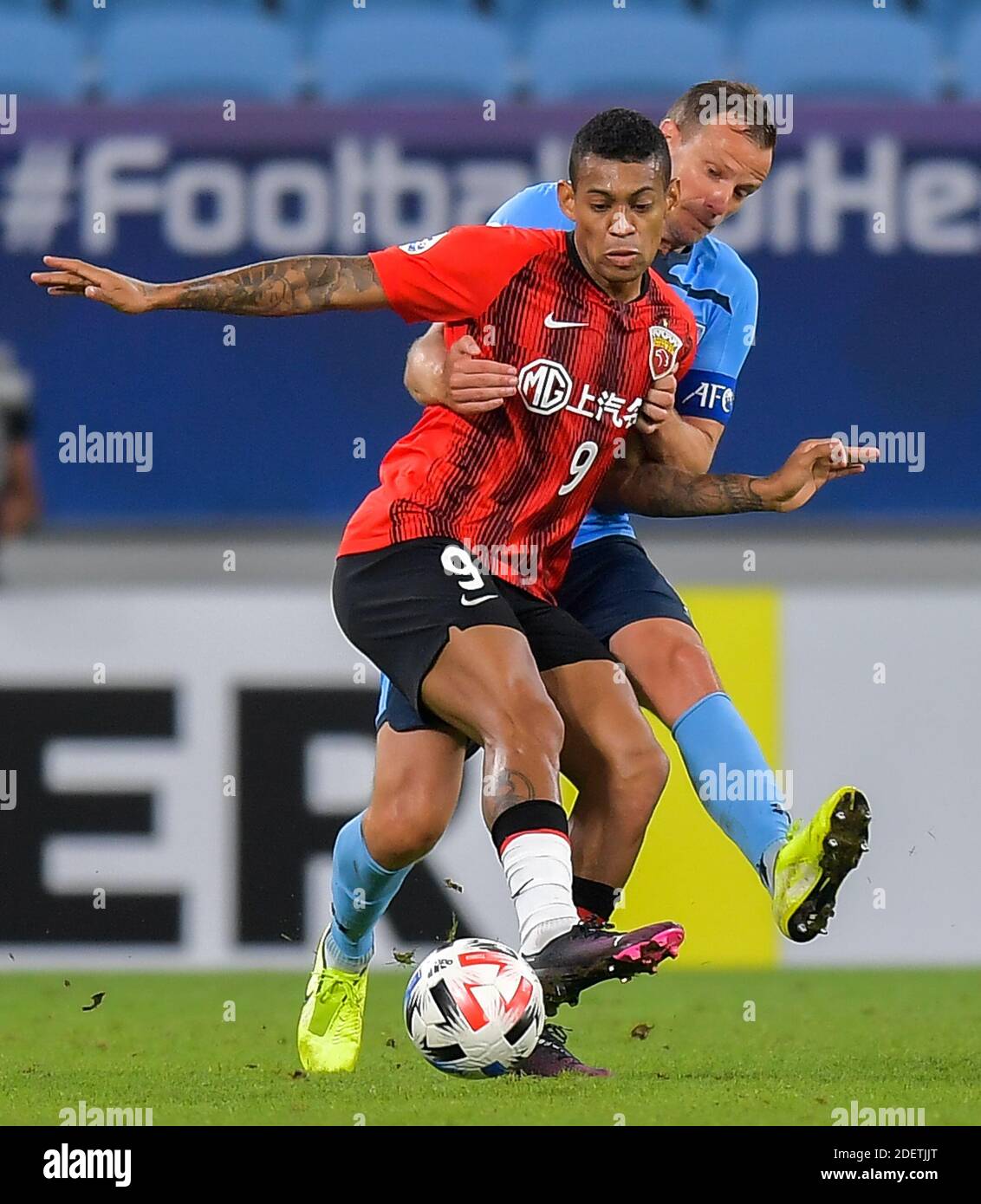 Doha, Qatar. 1st Dec, 2020. Ricardo Lopes (front) of Shanghai SIPG FC vies with Alex Wilkinson of Sydney FC during a Group H football match of the AFC Champions League between Shanghai SIPG FC of China and Sydney FC of Australia in Doha, Qatar, Dec. 1, 2020. Credit: Nikku/Xinhua/Alamy Live News Stock Photo