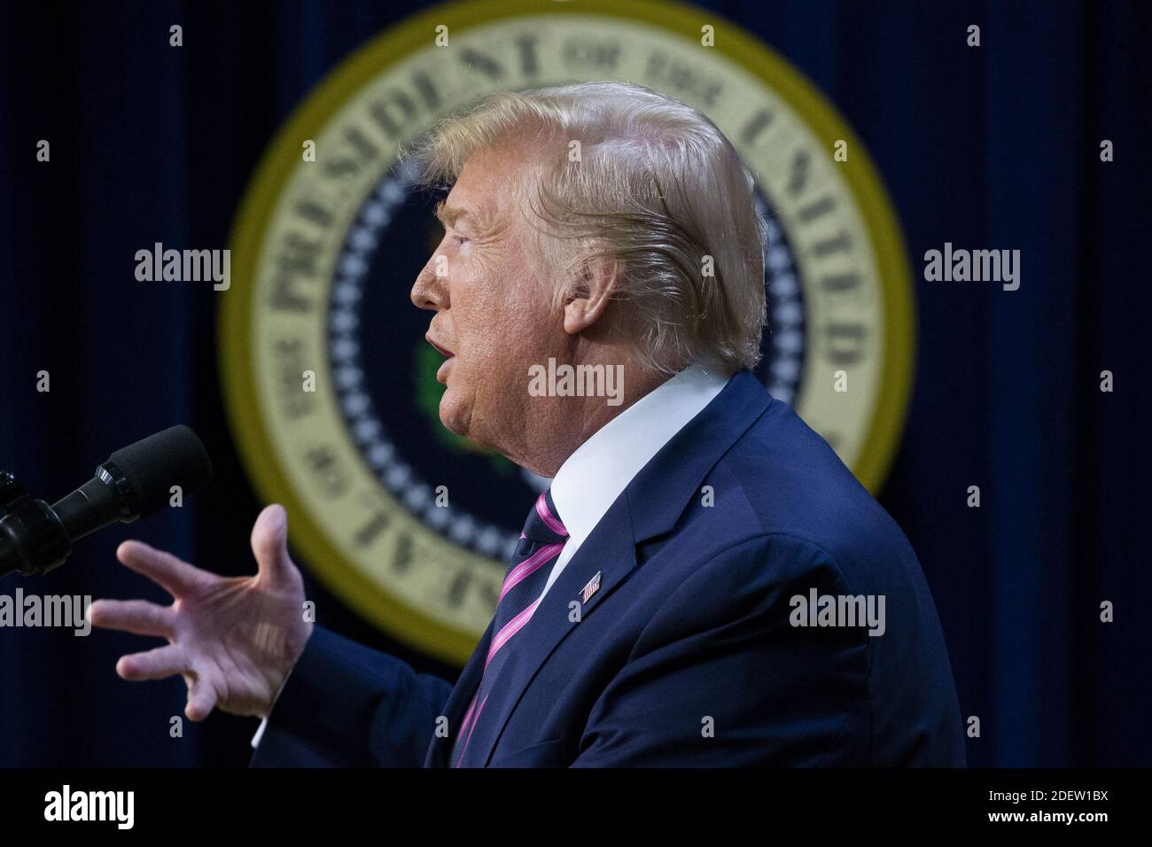 US President Donald J. Trump delivers remarks in front of the seal of ...