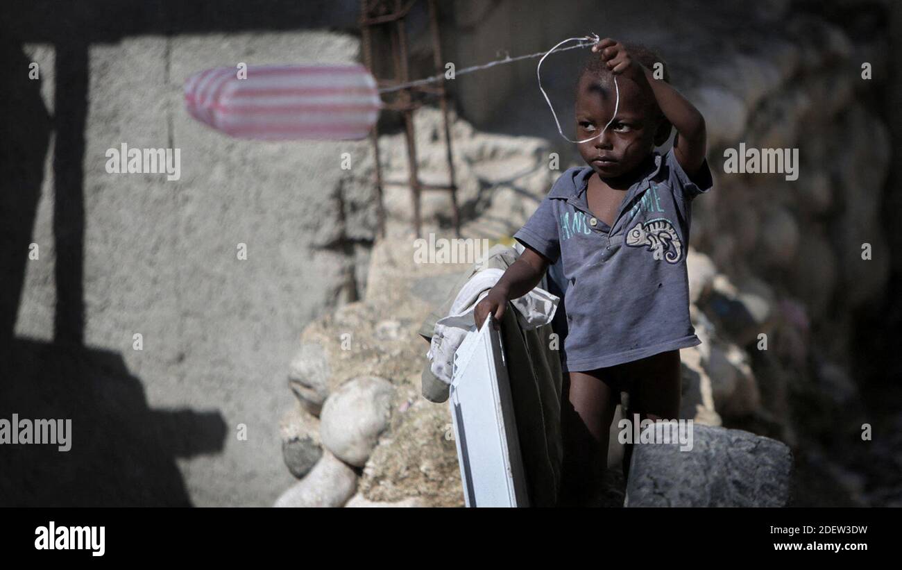 No Film No Video No Tv No Documentary A Young Child Uses A Plastic Bag As A Kite At Teren Toto Camp Ten Years After Haiti S 10 Earthquake The Camp Is