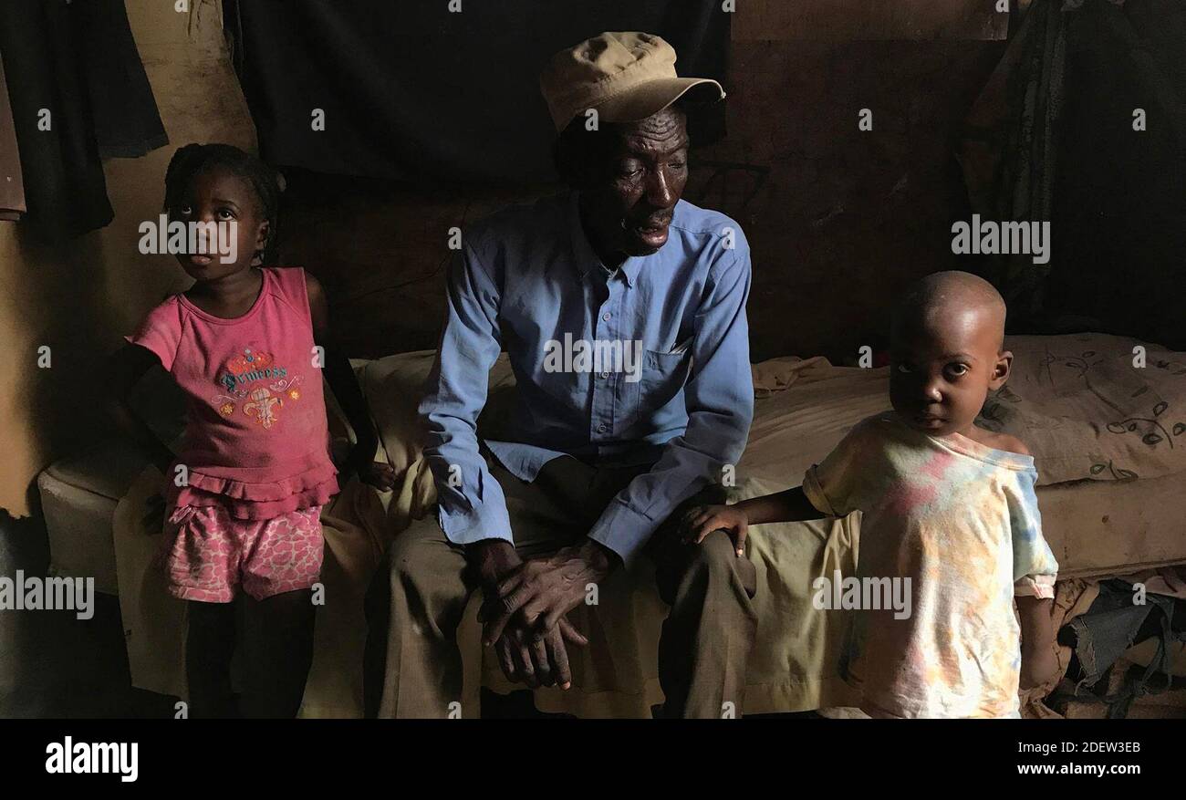 No Film No Video No Tv No Documentary Telfort Innocent Center With Two Of His 14 Children Inside His Family S Shack At The Teren Toto Camp The Camp Is One Of