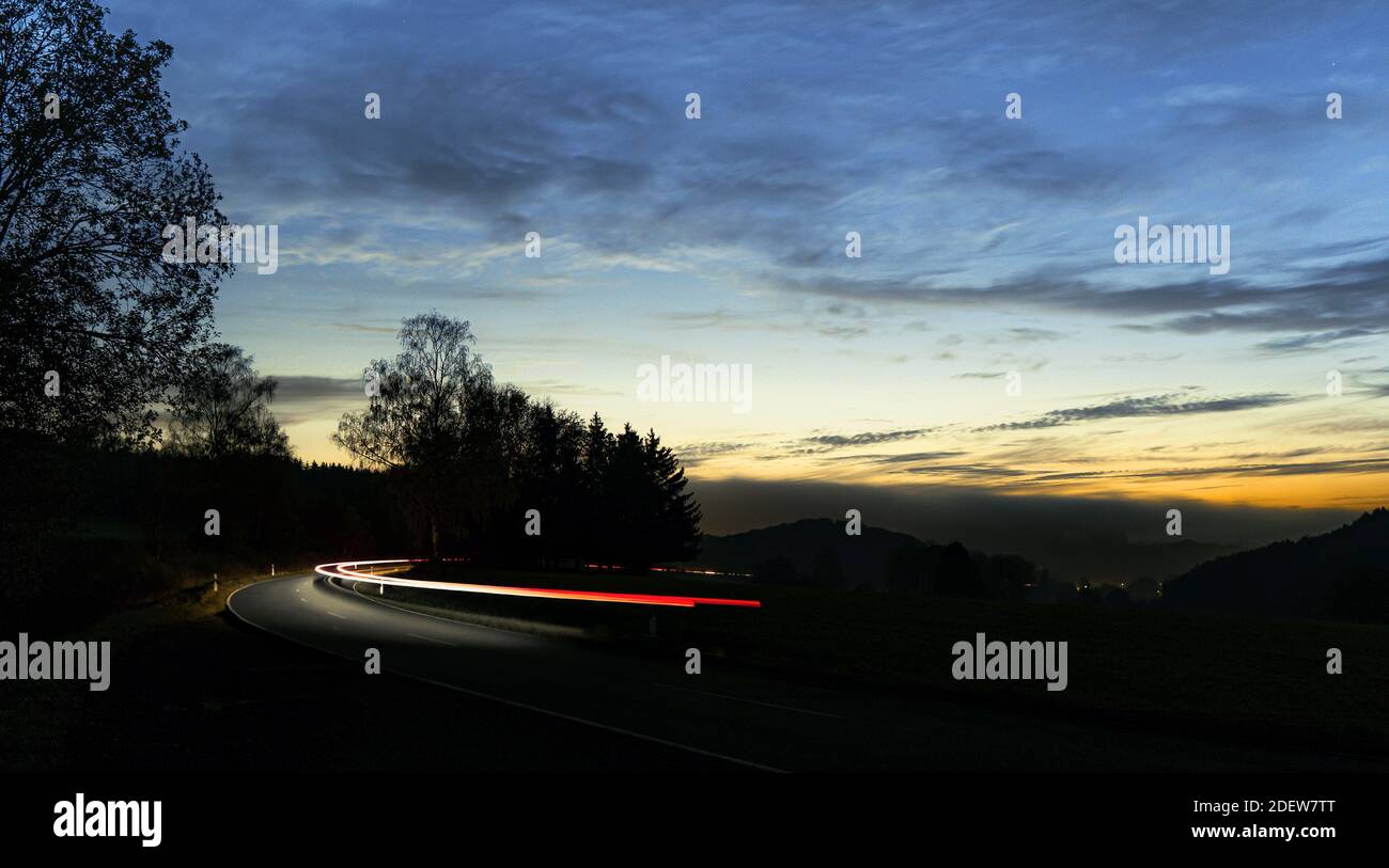 A a vehicle in the dark curved road Stock Photo
