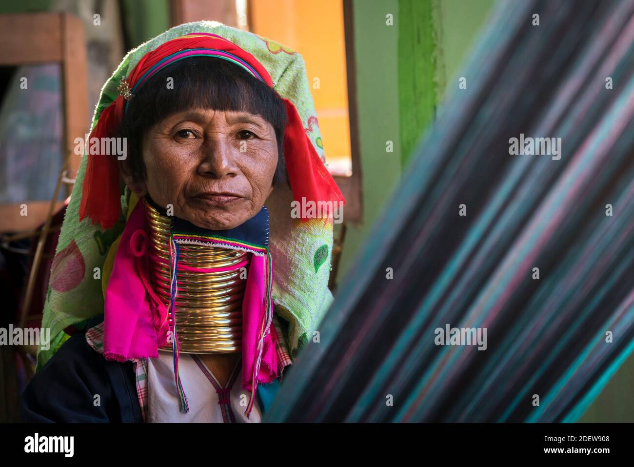 Portrait of senior Burmese woman from Kayan tribe weaving Stock Photo