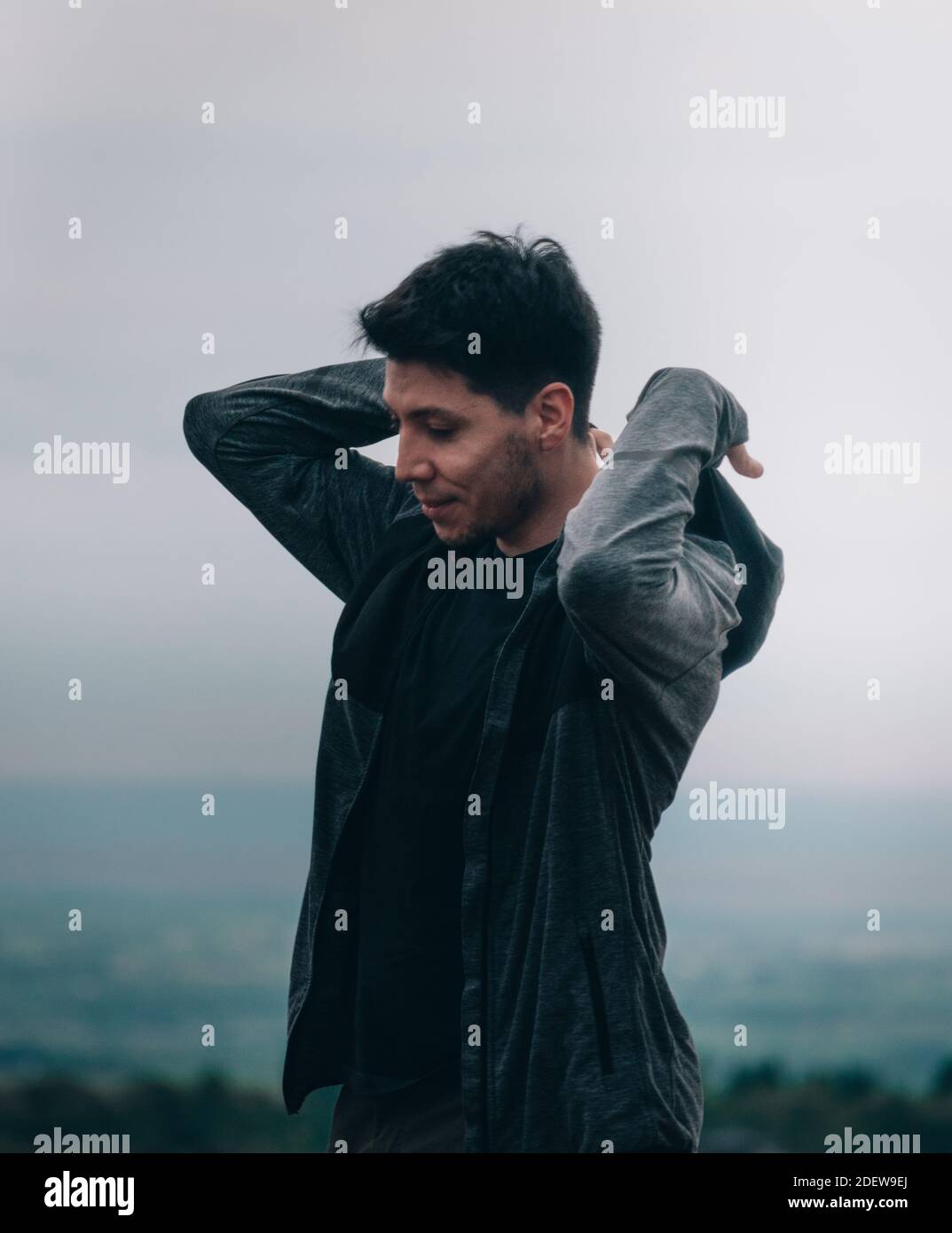 young man sheltering in mountains Stock Photo
