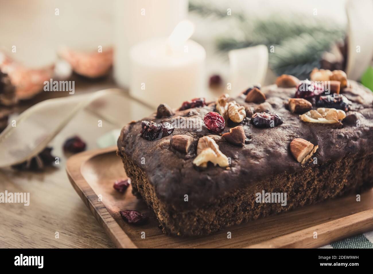Beautiful tasty dried mixed nut Christmas fruit cake on wooden table