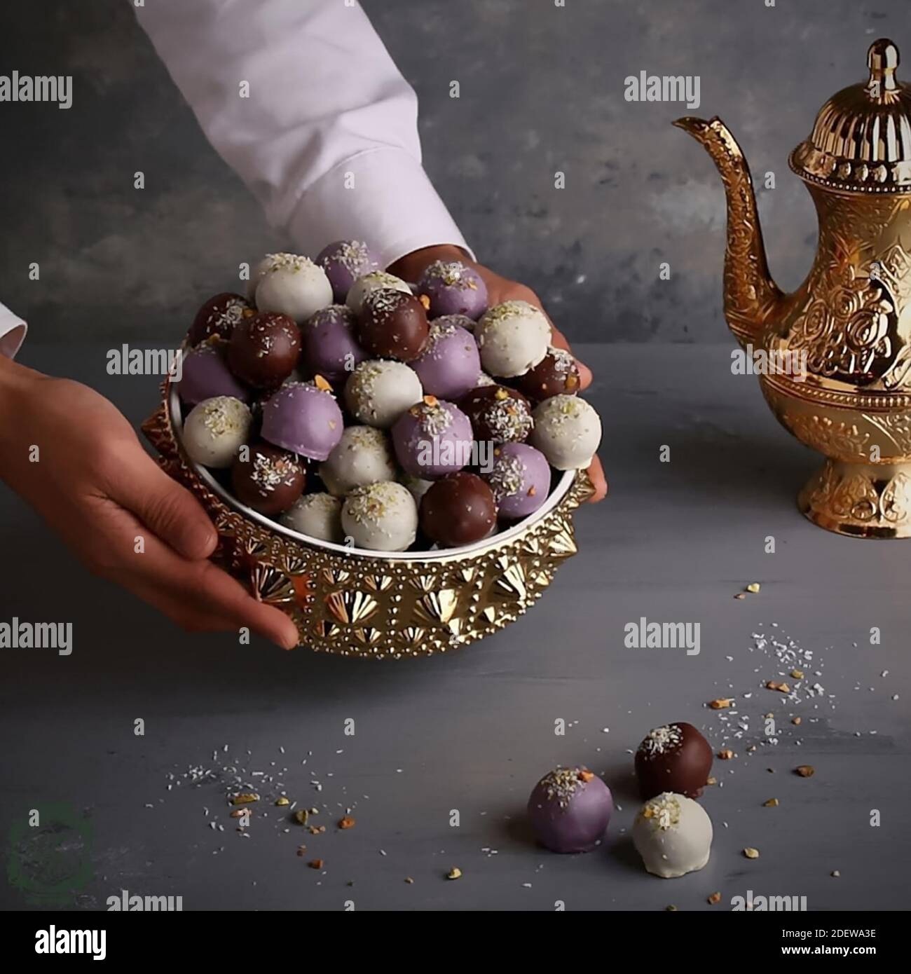 Colourful chocolate balls in the golden bowl. Stock Photo