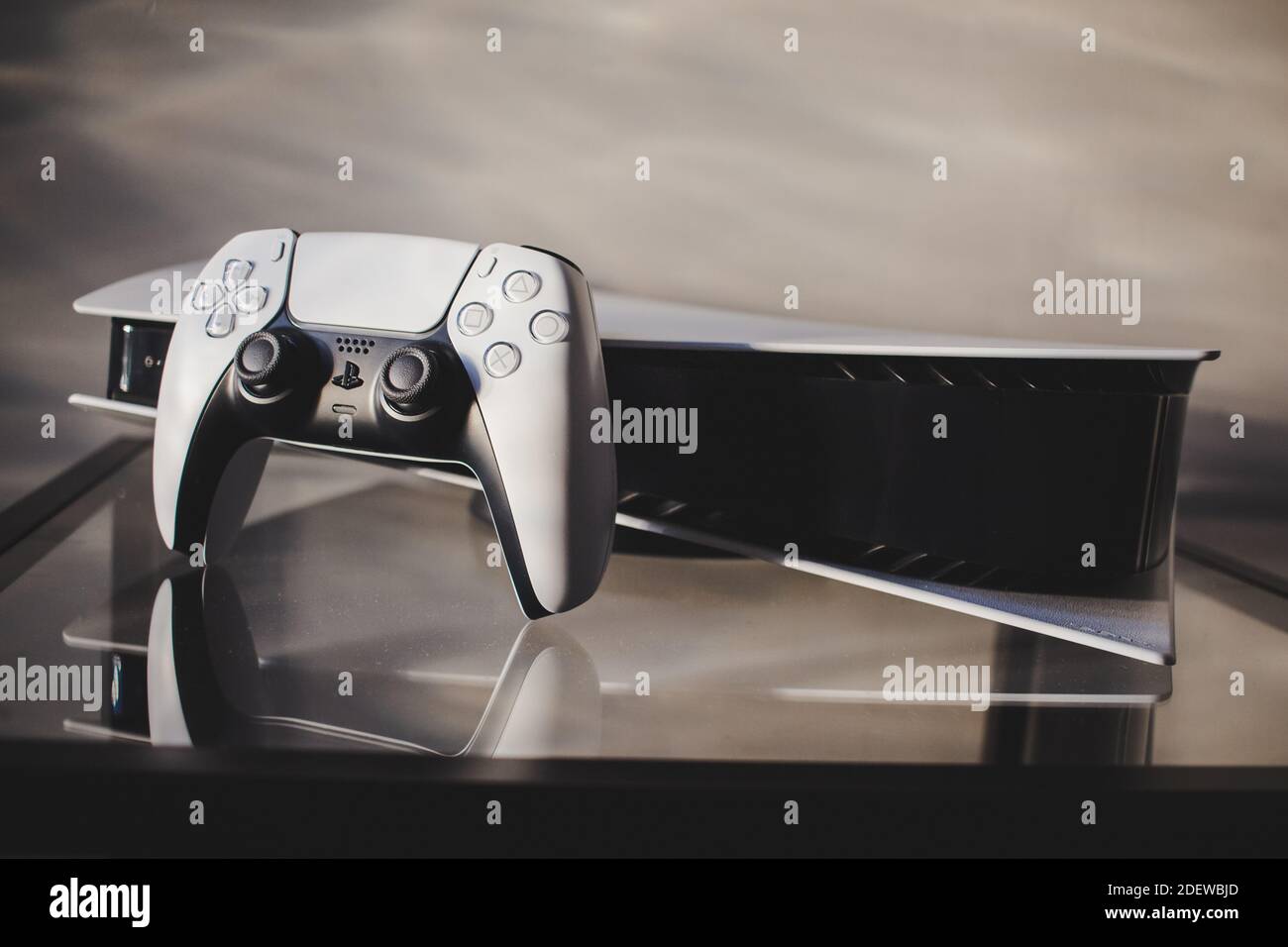 PlayStation 5 on its side with the DualSense controller Stock Photo