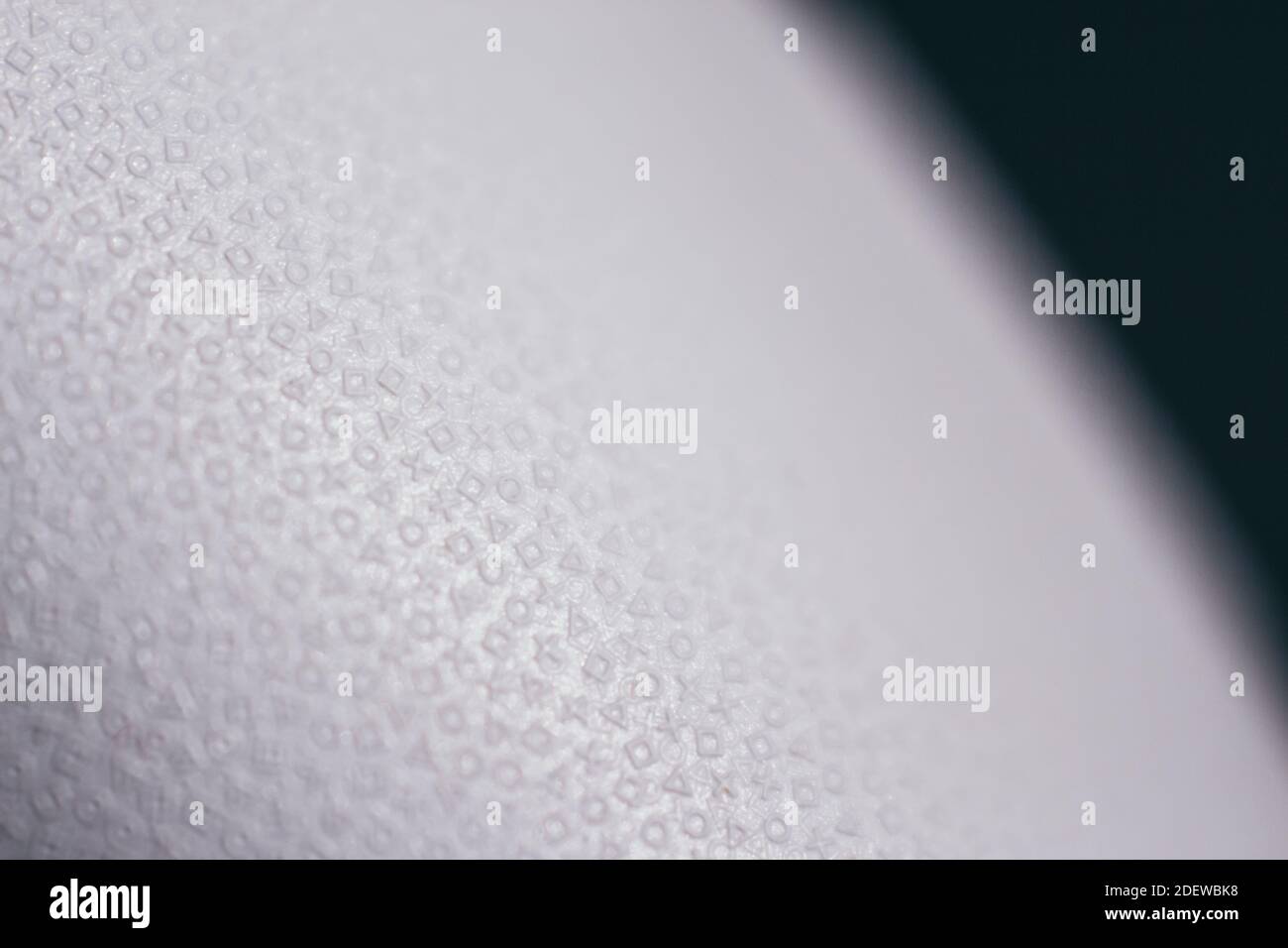 Close up details of iconic PlayStation symbols on the PlayStation 5