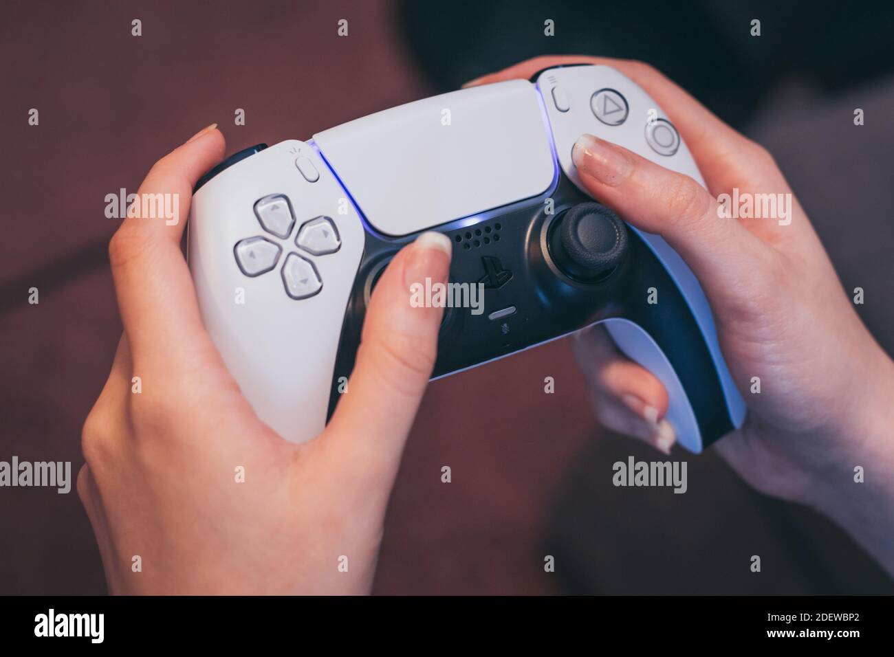 Person holding the PlayStation 5 DualSense gaming controller Stock
