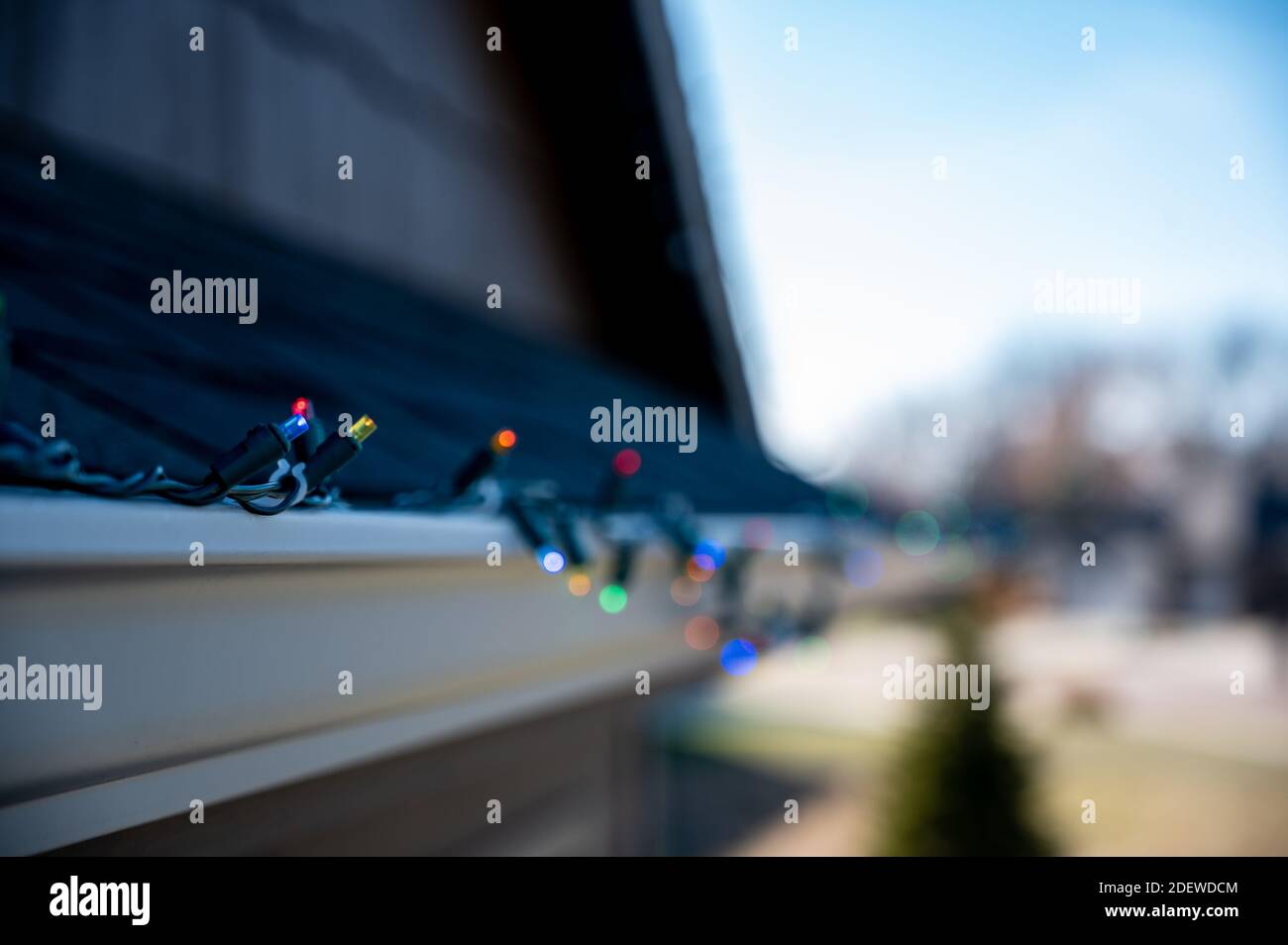Hanging Christmas lights on gutter with plastic clips Stock Photo Alamy