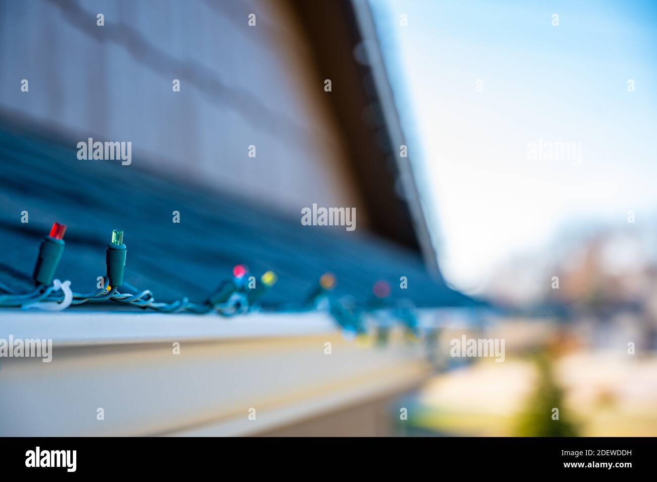 Hanging Christmas lights on gutter with plastic clips Stock Photo Alamy