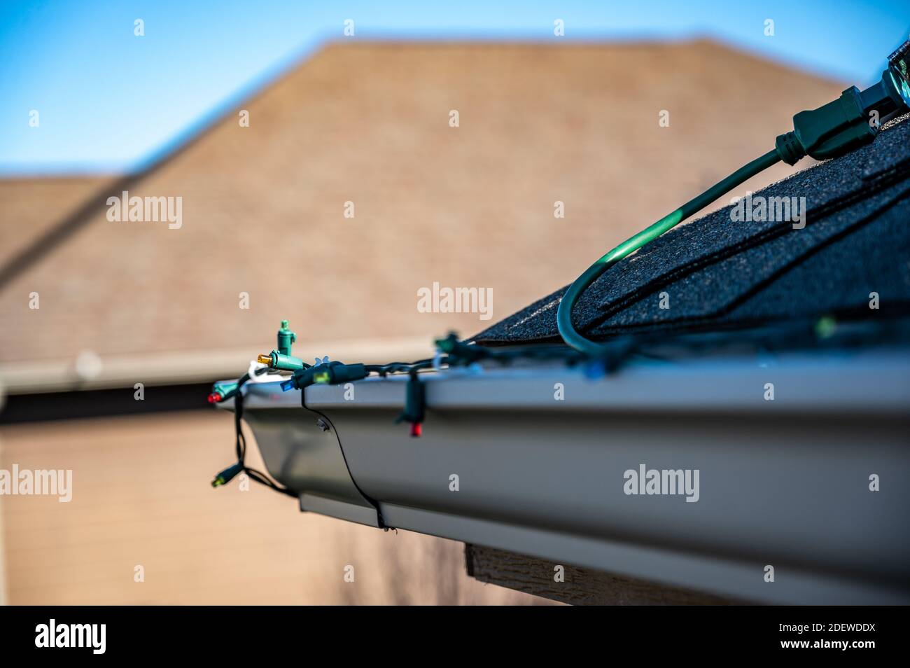 Hanging Christmas lights on gutter with plastic clips Stock Photo Alamy