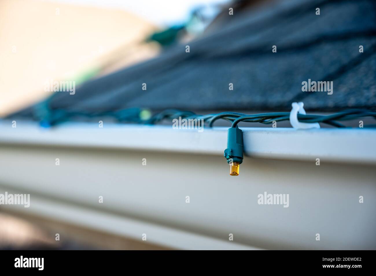 Hanging Christmas lights on gutter with plastic clips Stock Photo Alamy