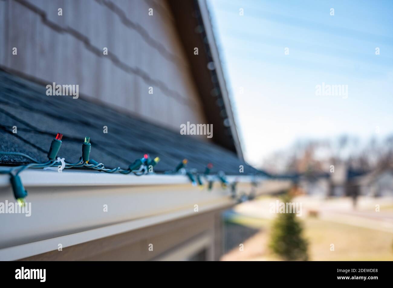 Hanging Christmas lights on gutter with plastic clips Stock Photo Alamy