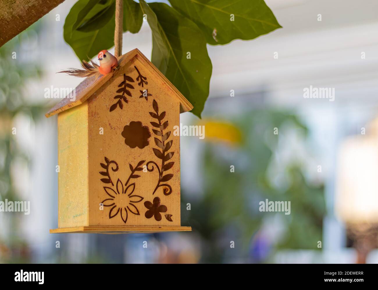 Wooden birdhouse on a tree in the garden. Close up, selective focus, blurred background, nobody. Stock Photo