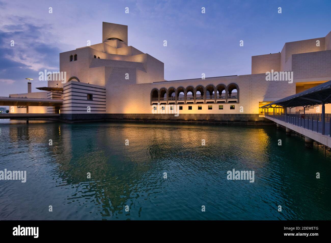 Museum of Islamic Art, Doha, Qatar at dusk exterior view  showing the modern architecture of the building with light reflection in the Arabic gulf and Stock Photo