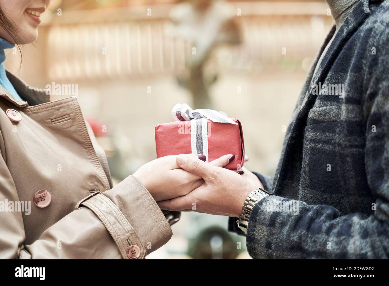 young asian woman ceceiving a christmas or birthday present from husband or boyfriend Stock Photo