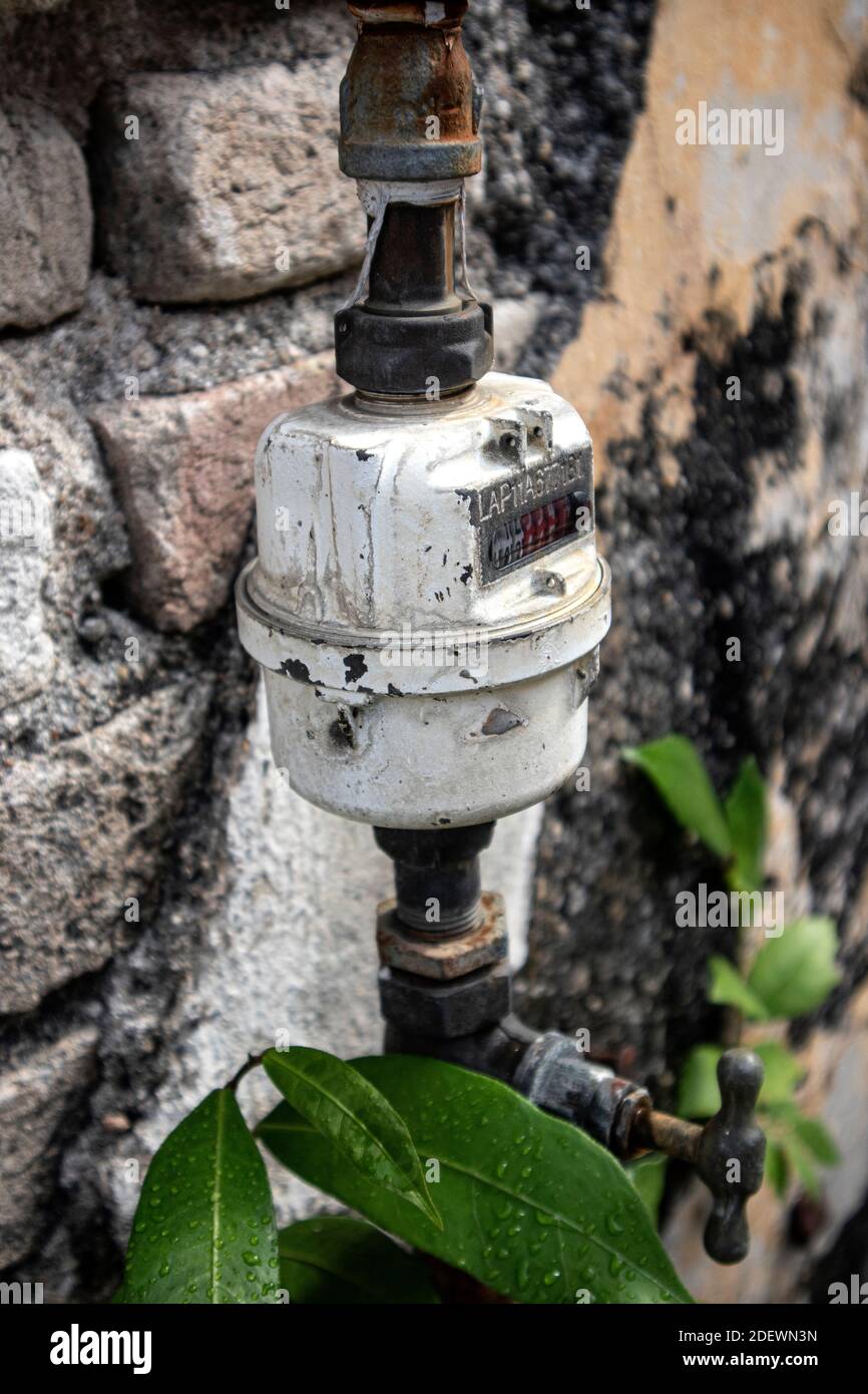 Old water metering unit, metal pipes outdoor building Stock Photo