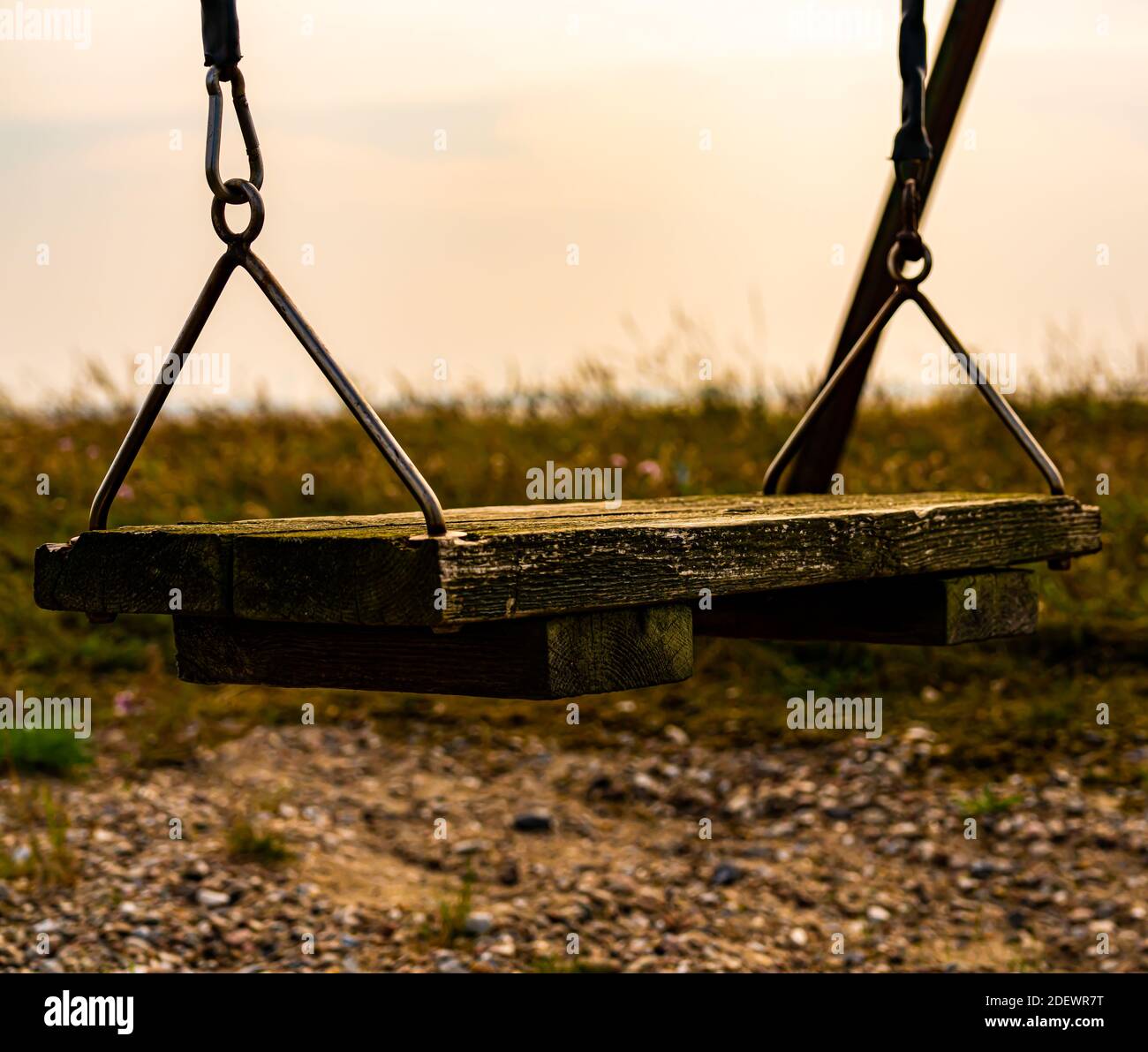 Old weathered swing made from wood planks, looking desolate. . High quality photo Stock Photo