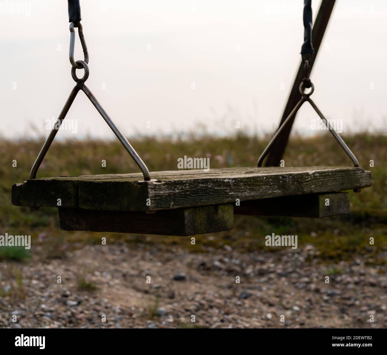 Old weathered swing made from wood planks, looking desolate. . High quality photo Stock Photo