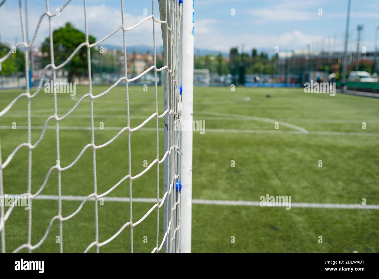 Soccer Net Background View From Behind The Goal With Blurred Stadium And Field Pitch Stock Photo Alamy