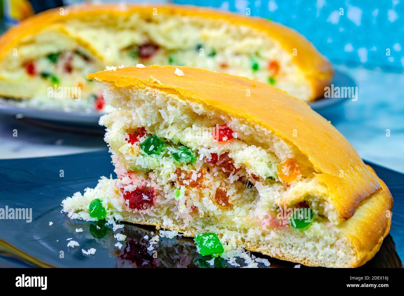 Closeup of tutti frutti and desiccated coconut stuffed dilkush piece in a black plate. Stock Photo