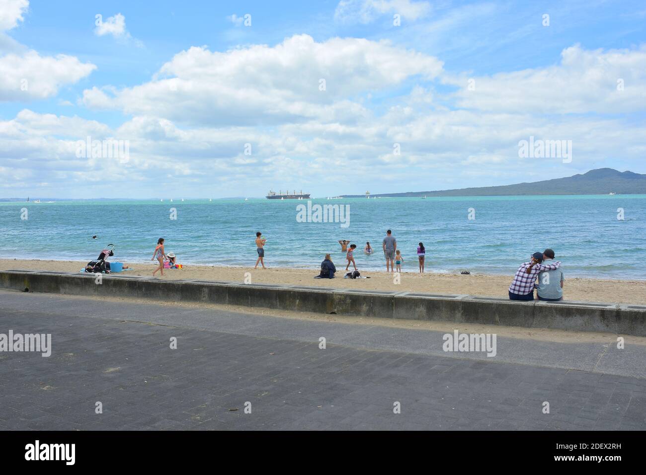 AUCKLAND, NEW ZEALAND - Nov 21, 2020: View of people at Mission Bay beach with Rangitoto Island in background Stock Photo
