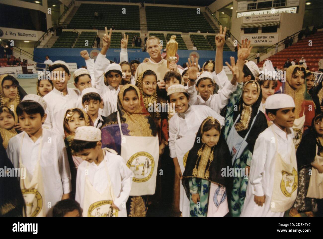 Children around the tennis tournament winner, Qatar 1990s Stock Photo
