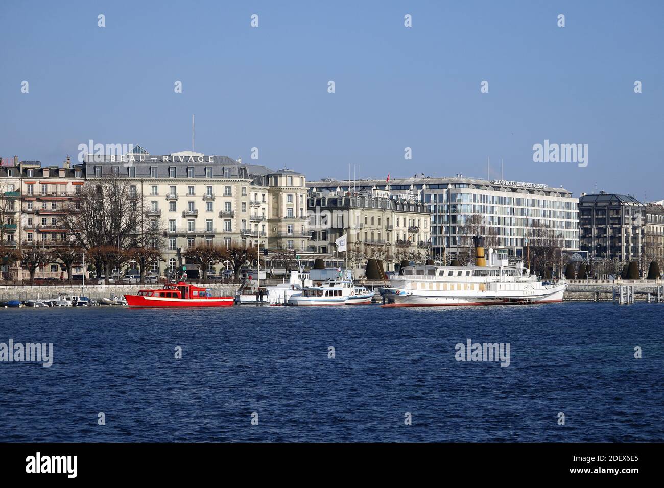 GENEVA, SWITZERLAND - Feb 20, 2018: City trip in Geneva during winter. Picture shows boats on the lake and buildings in the background. Stock Photo